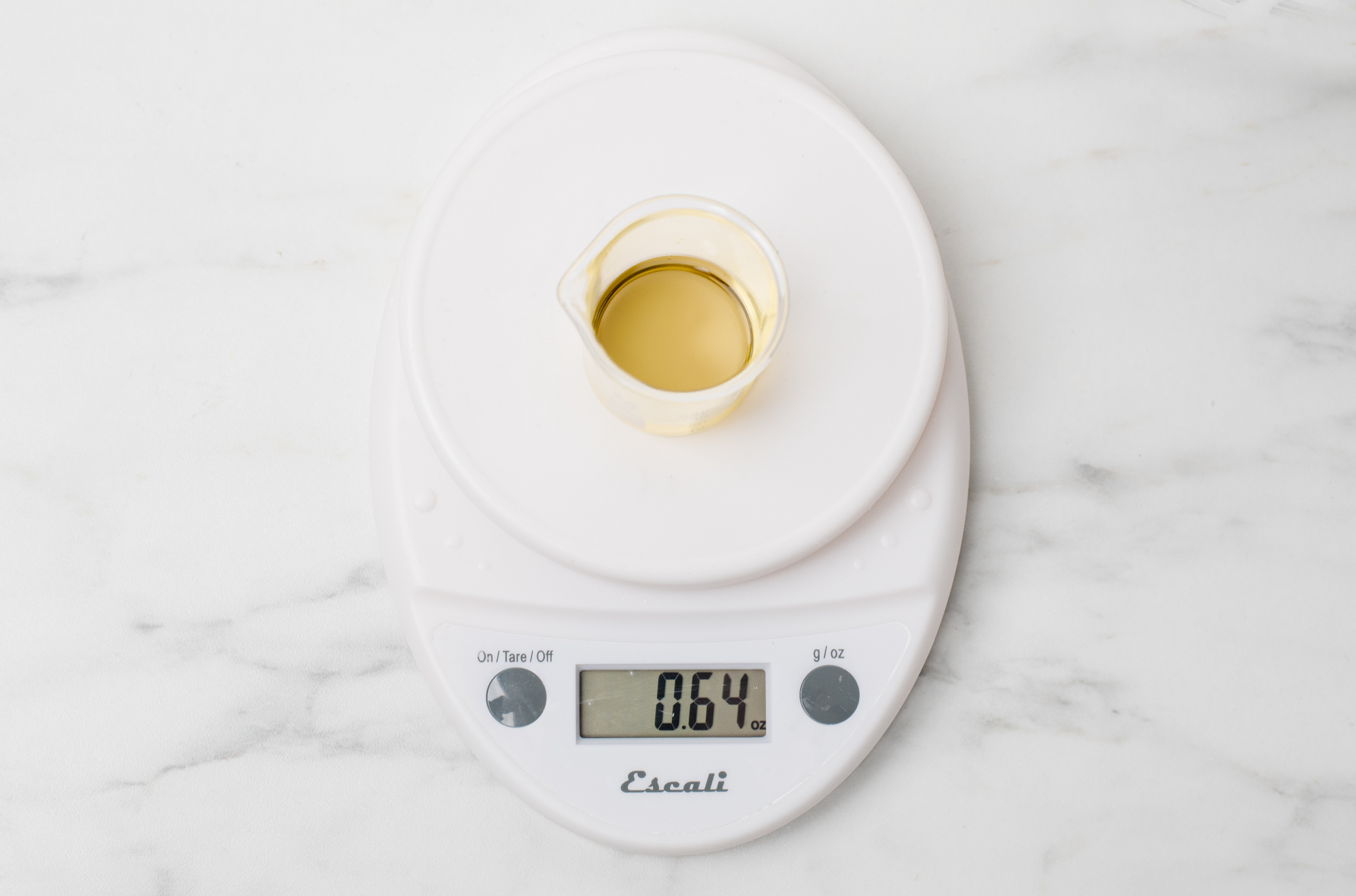Weighing essential oil on a digital scale.